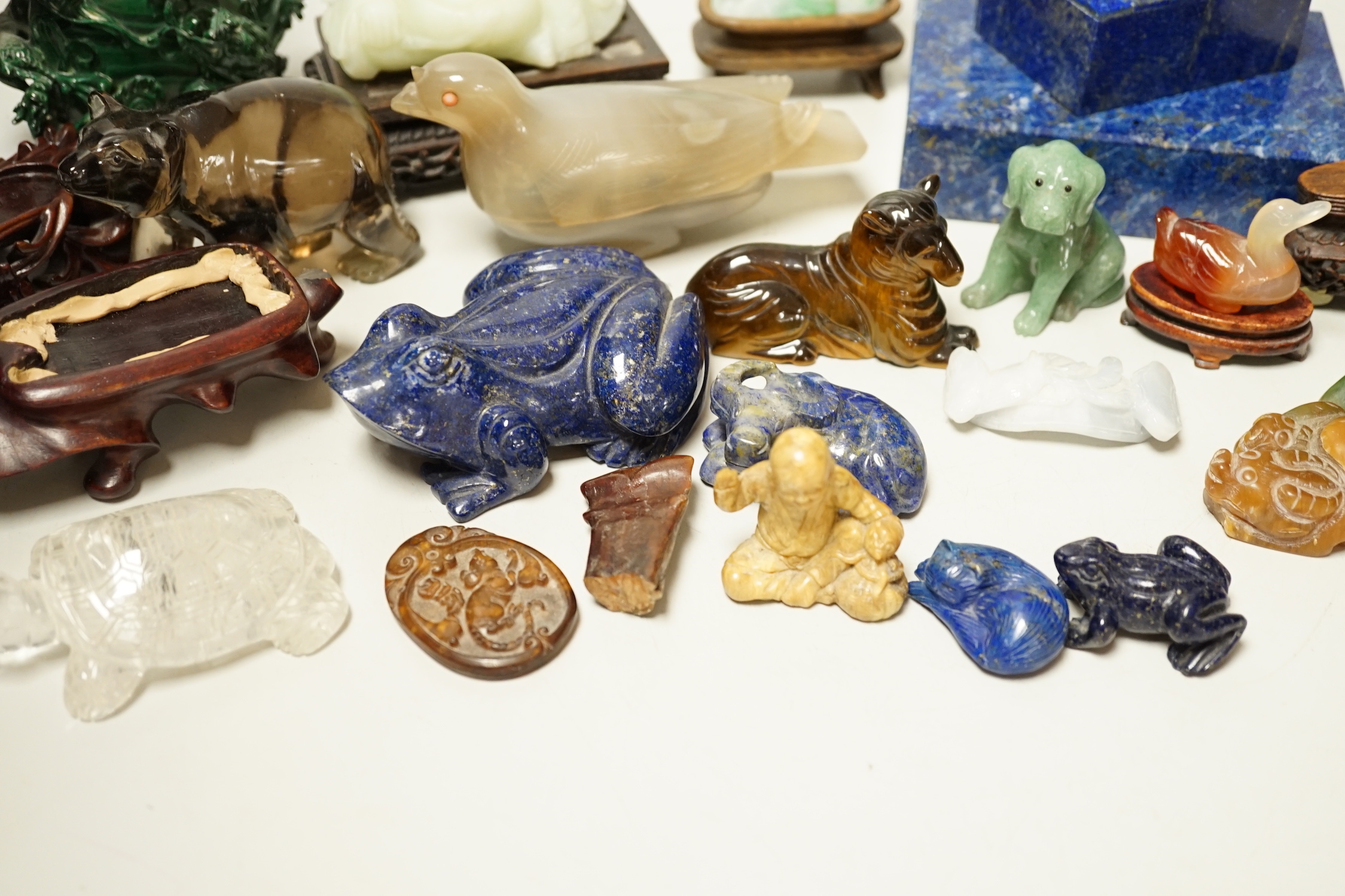 A collection of assorted Chinese hardstone carvings, boxes etc, including a Chinese jadeite carving of a lady, 7.8cm high, wood stand
